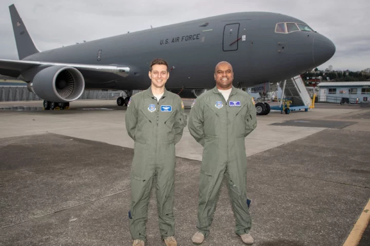 Nick Cenci, Major, USAF Chief of Flight Operations DCMA (Seattle) (left) and Anthony Mariapain, Major, USAF KC-46 Chief Pilot DCMA (Seattle) stand in front of the KC-46A Pegasus at Boeing Field in advance of the U.S. Air Force acceptance of Boeing’s first tanker