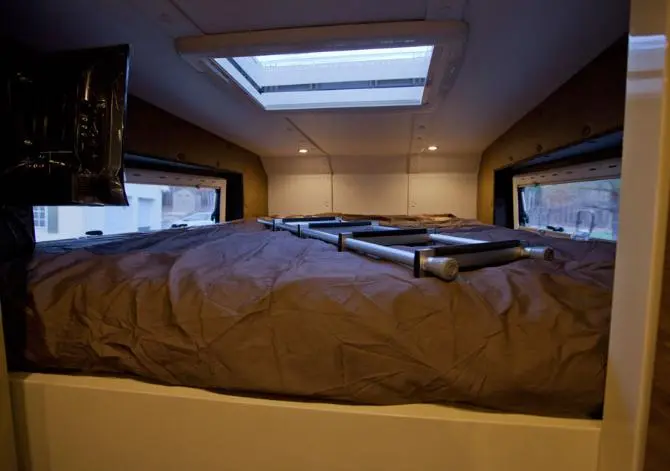 The upper sleep area has a king-sized bed, skylight and swivel-mount television