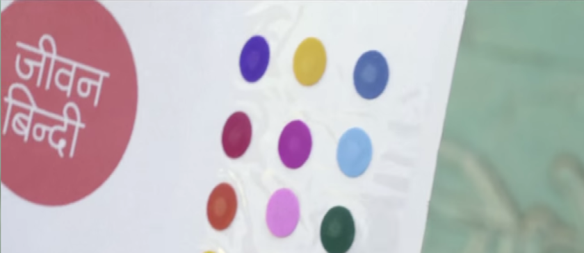 The "life-saving dot" is colorful and self-adhesive, like many other cosmetic bindis available in India