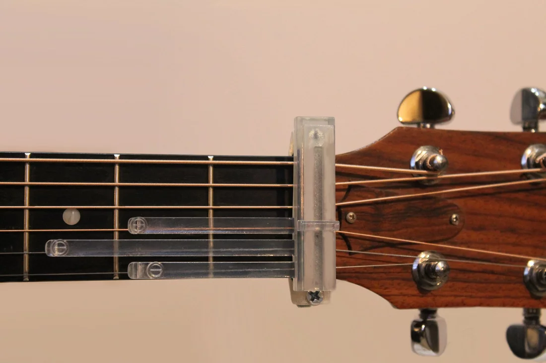 Each chord insert tab has a callus builder button at the optimum finger position