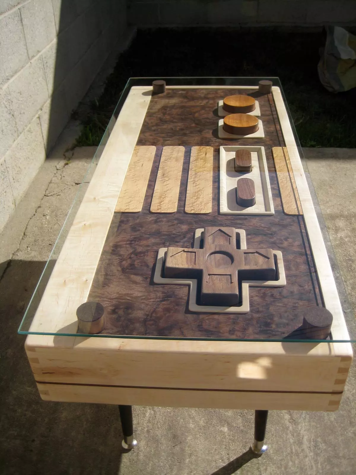The table features a huge wooden four-way directional pad, Start, Select and action buttons