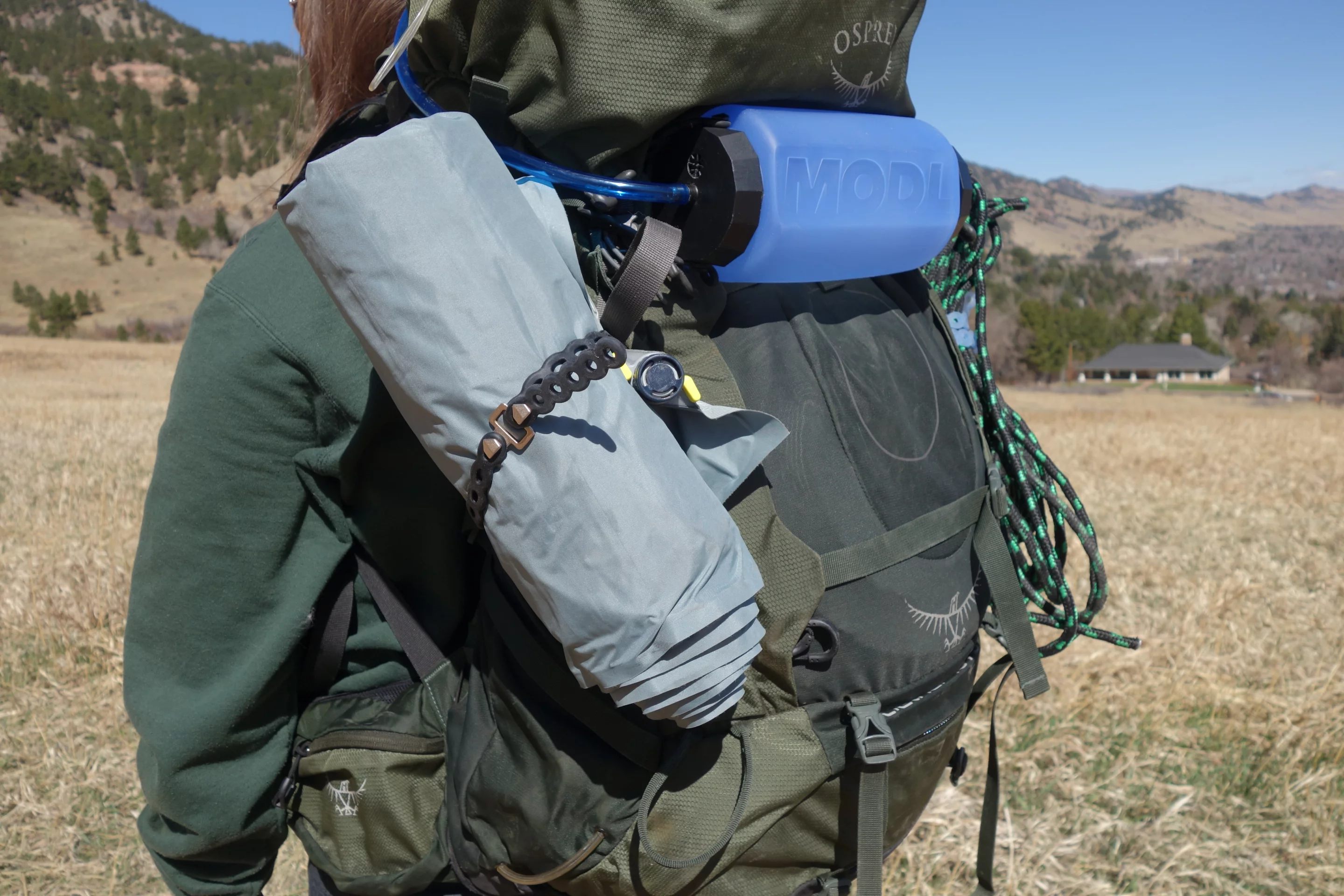 MODL sneaks a peek of its modular water bottle into this photo of its straps finding use on a backpacking trip