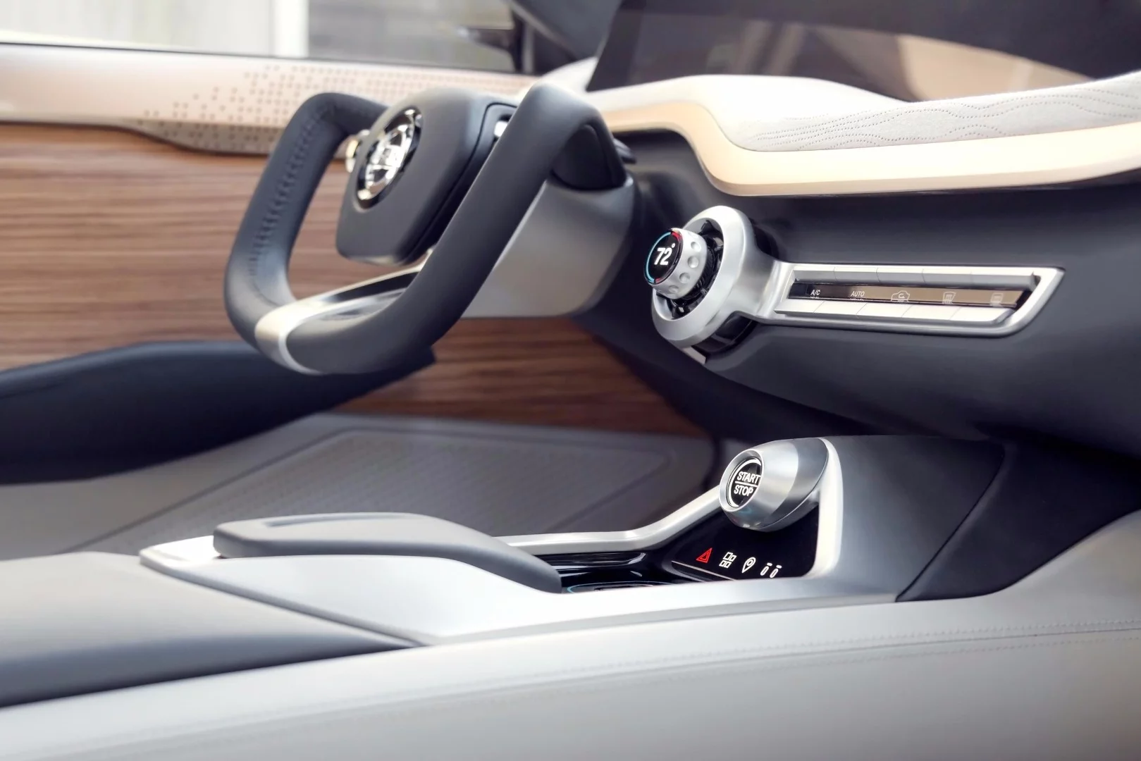 A square-shaped, Indy-inspired steering wheel with a T-shaped spoke design houses a few simple control buttons