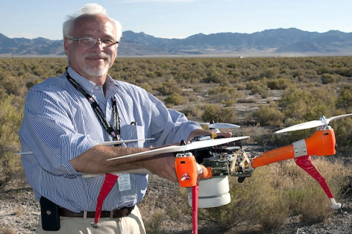 ECBC Director, Joseph Corriveau, with Deep Purple, one of two drones used to sniff out chemical and biological agents in a recent two-week test