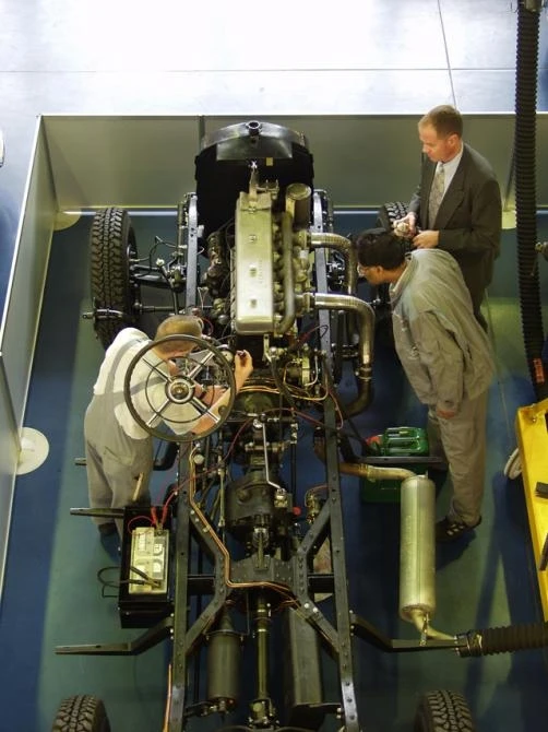 Craftsmen going about their work on this rare vehicle.