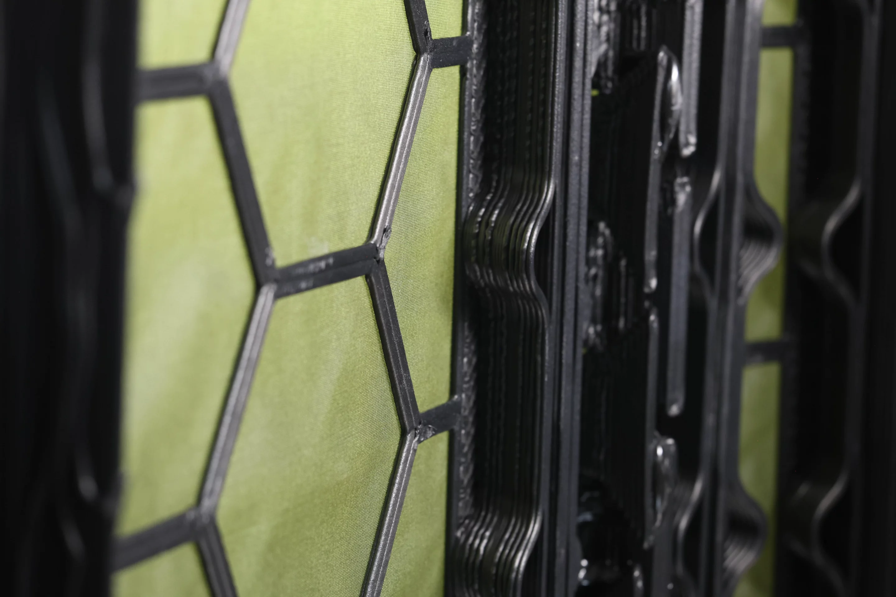 Each panel consists of the fabric base (green) and the 3D-printed structural grid (black)