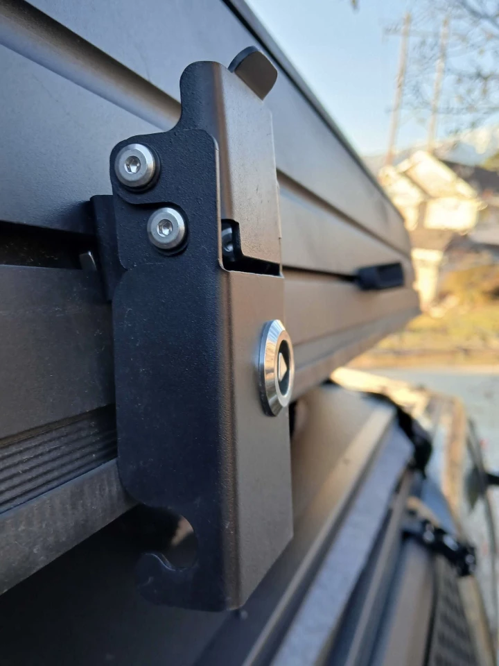 Topoak's latches are beefier than some we've used on more expensive tents. This one is opened in the picture by pulling down on the tab at the top to lower the hooked bottom off the closure bar below and pull it off