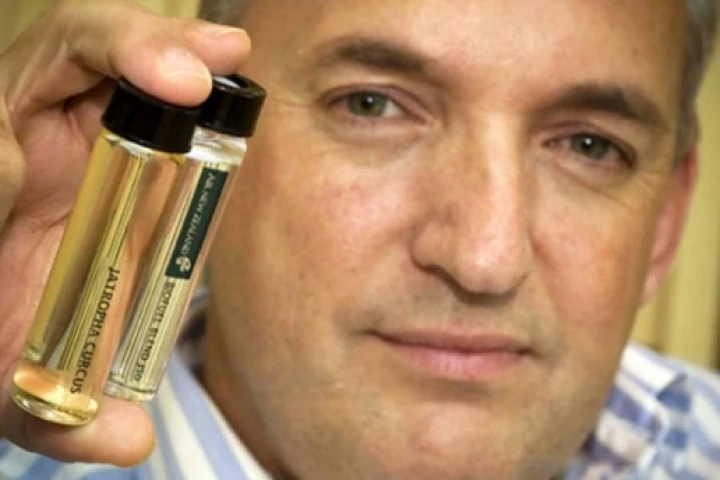 Air New Zealand's Captain David Morgan holds samples of the oil and biofuel blend