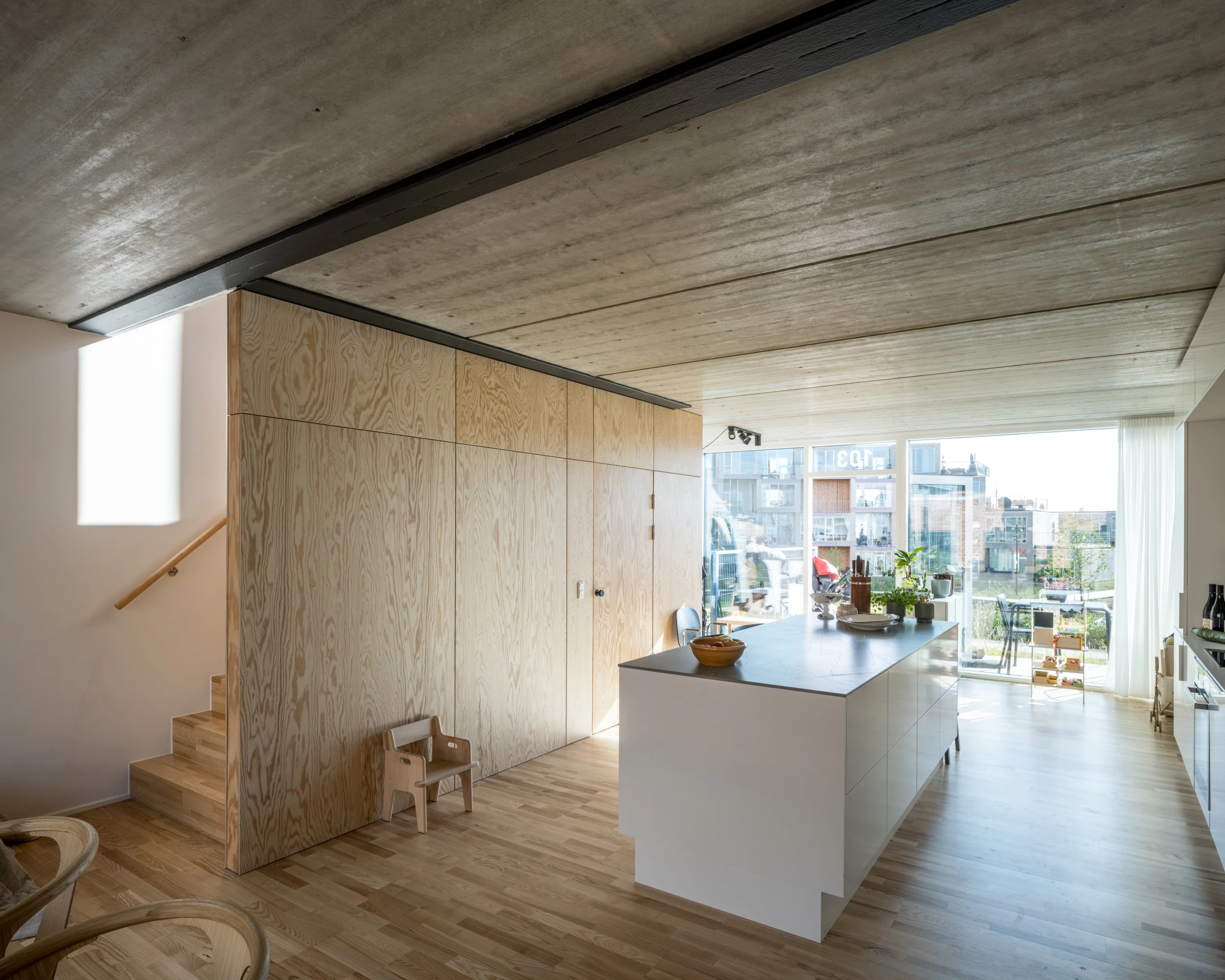 The Sneglehusene's interior decor features a utilitarian mixture of exposed concrete and wood
