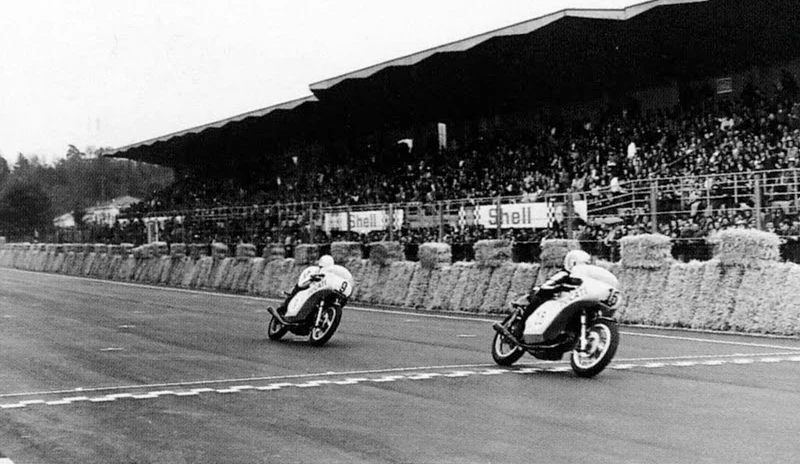 Paul Smart and Bruno Spaggiari cross the line in motorcycling's most famous 1-2 victory - the 1972 Imola 200 Mile Race. Spaggiari's bike failed to sell at auction in 2006.