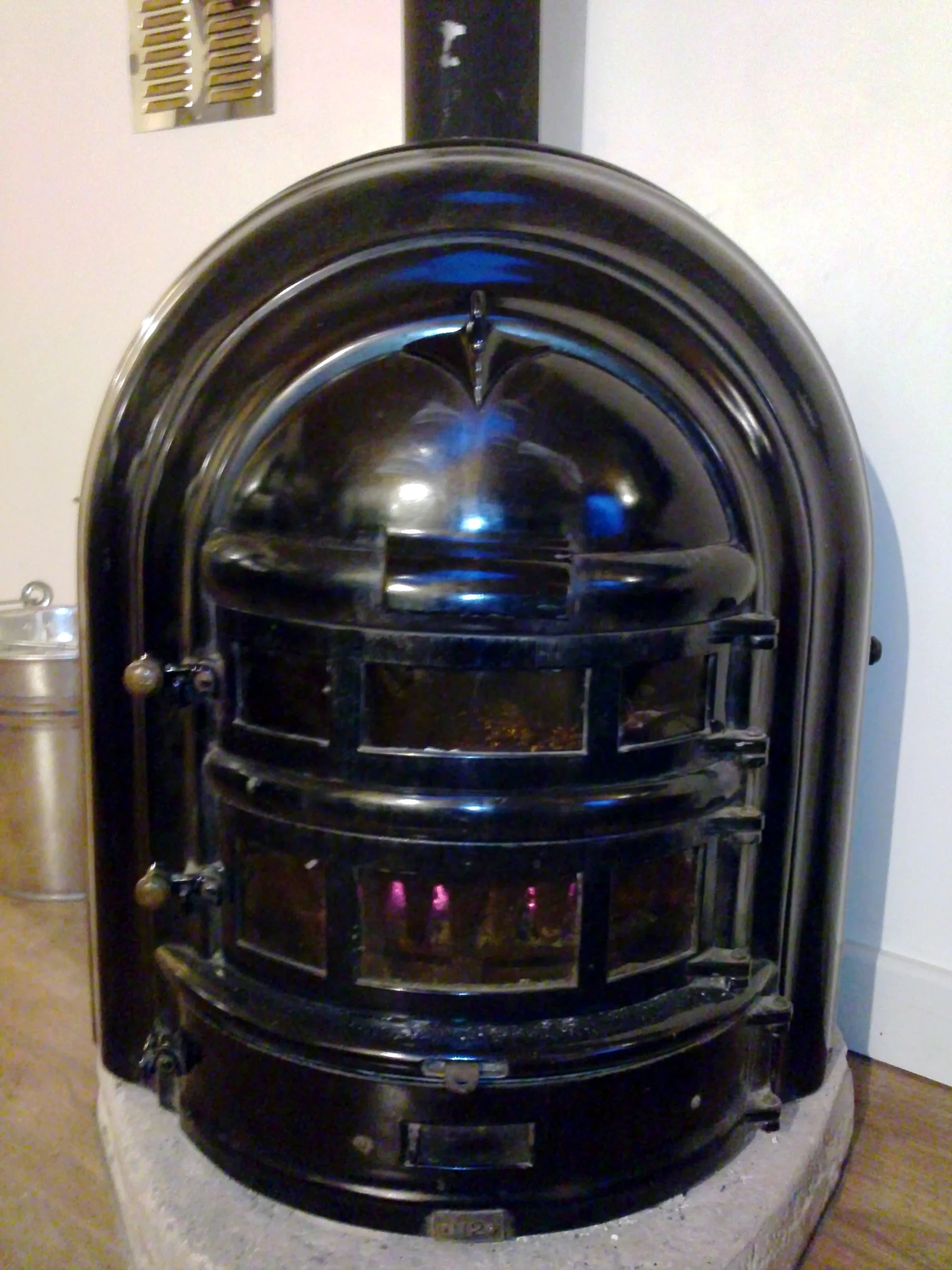Close up of the chocolate-colored Bauhaus style 1930's wood-burning stove