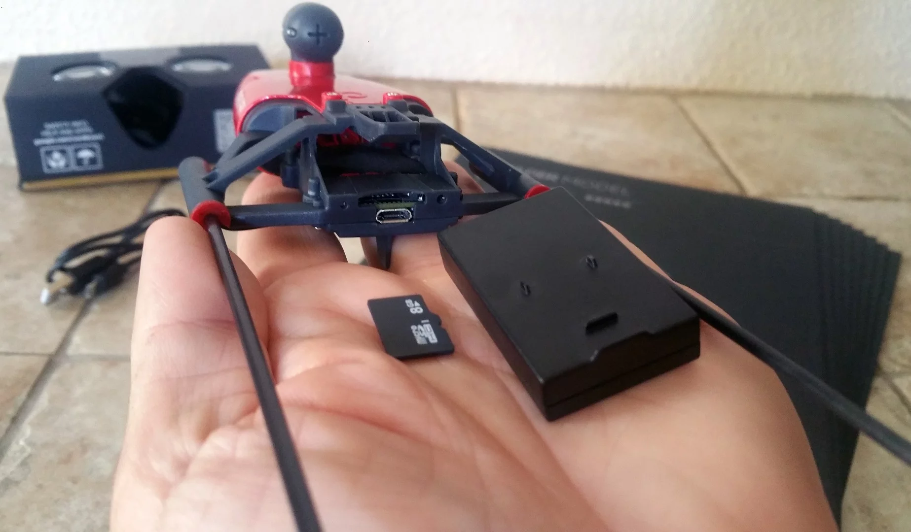 The rear of PowerUp FPV's main body houses the battery, microSD card slot, and USB port for recharging