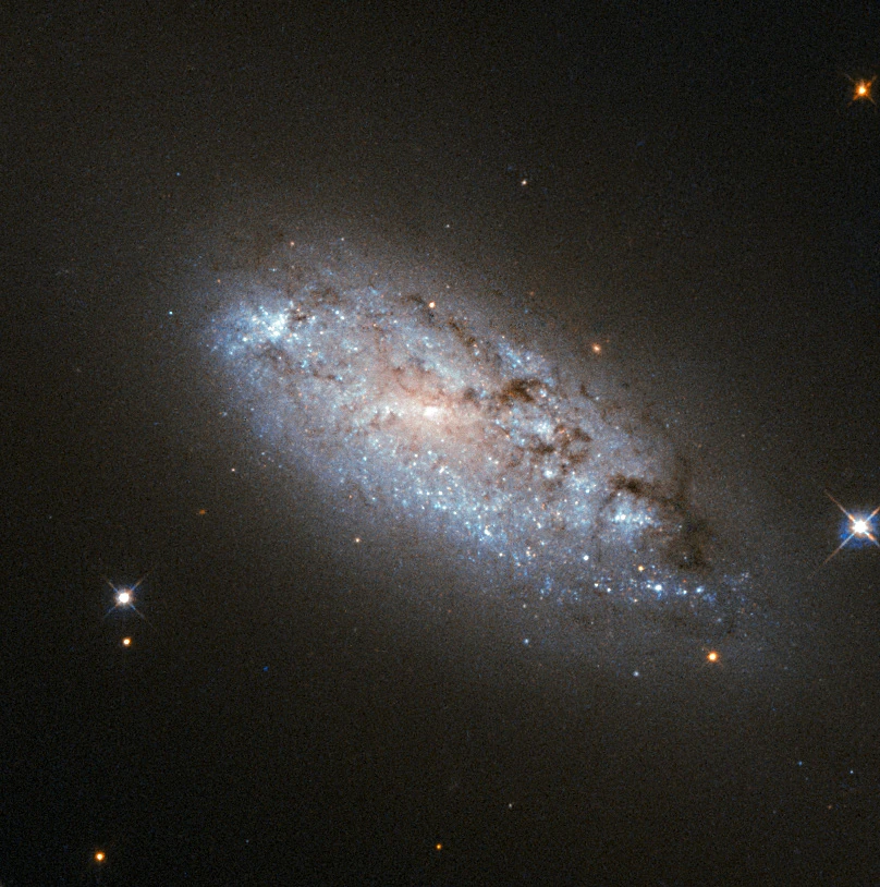 This image provides the clearest ever view of galaxy NGC 949, which lies over 30 million light-years away in the constellation of Triangulum. The galaxy has an unusual shape, made more obscure due to its inclination. From our point of view, it is difficult to discern exactly what type of galaxy NGC 949 is, but it is certainly a disc galaxy of some kind, most likely a spiral