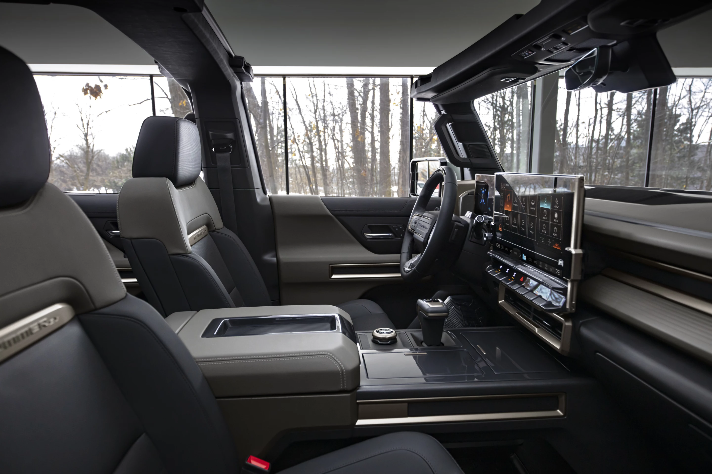 Seating for five in the Hummer EV includes a large infotainment screen, storage options, and USB plugs throughout the cabin