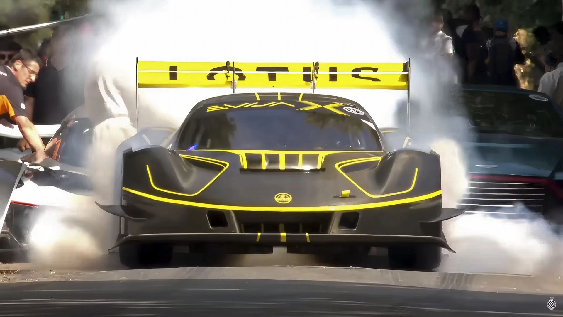 The Lotus Evija X does a huge smokey burnout leaving the start line before crashing violently into the hay bales