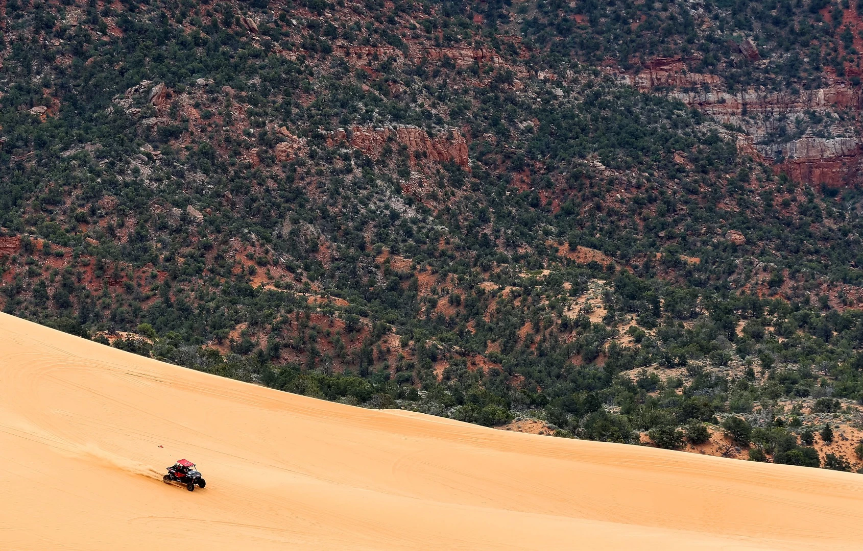 The author sails down a dune headed for certain disaster when he attempts to create epic rooster tails of sand, but superior skill (luck) saves the day