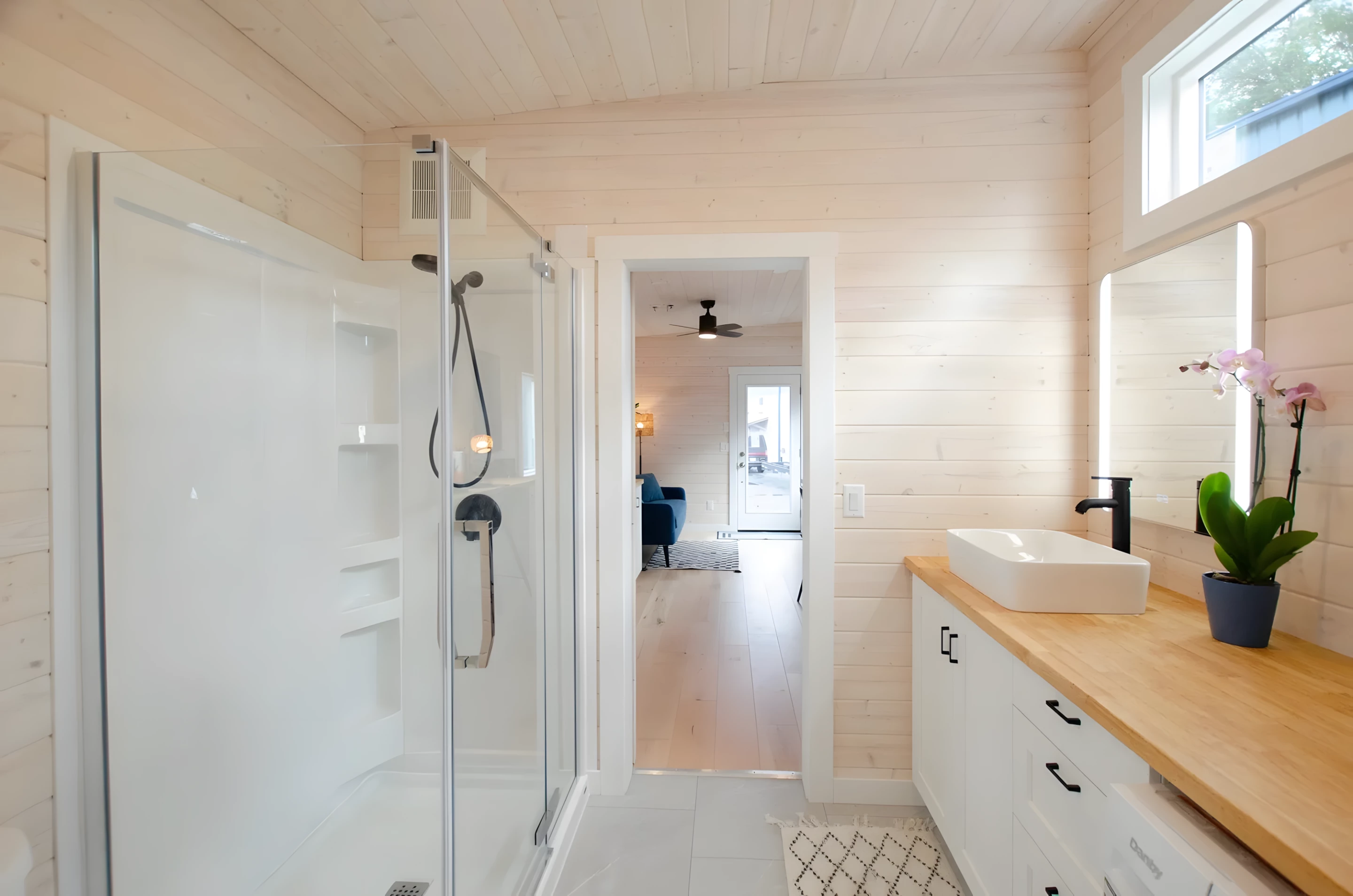 The Barred Owl's bathroom features a large walk-in shower, a sink, and a flushing toilet