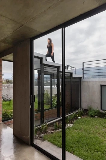 The glass walls allow natural light to filter through to the lower sections of the home
