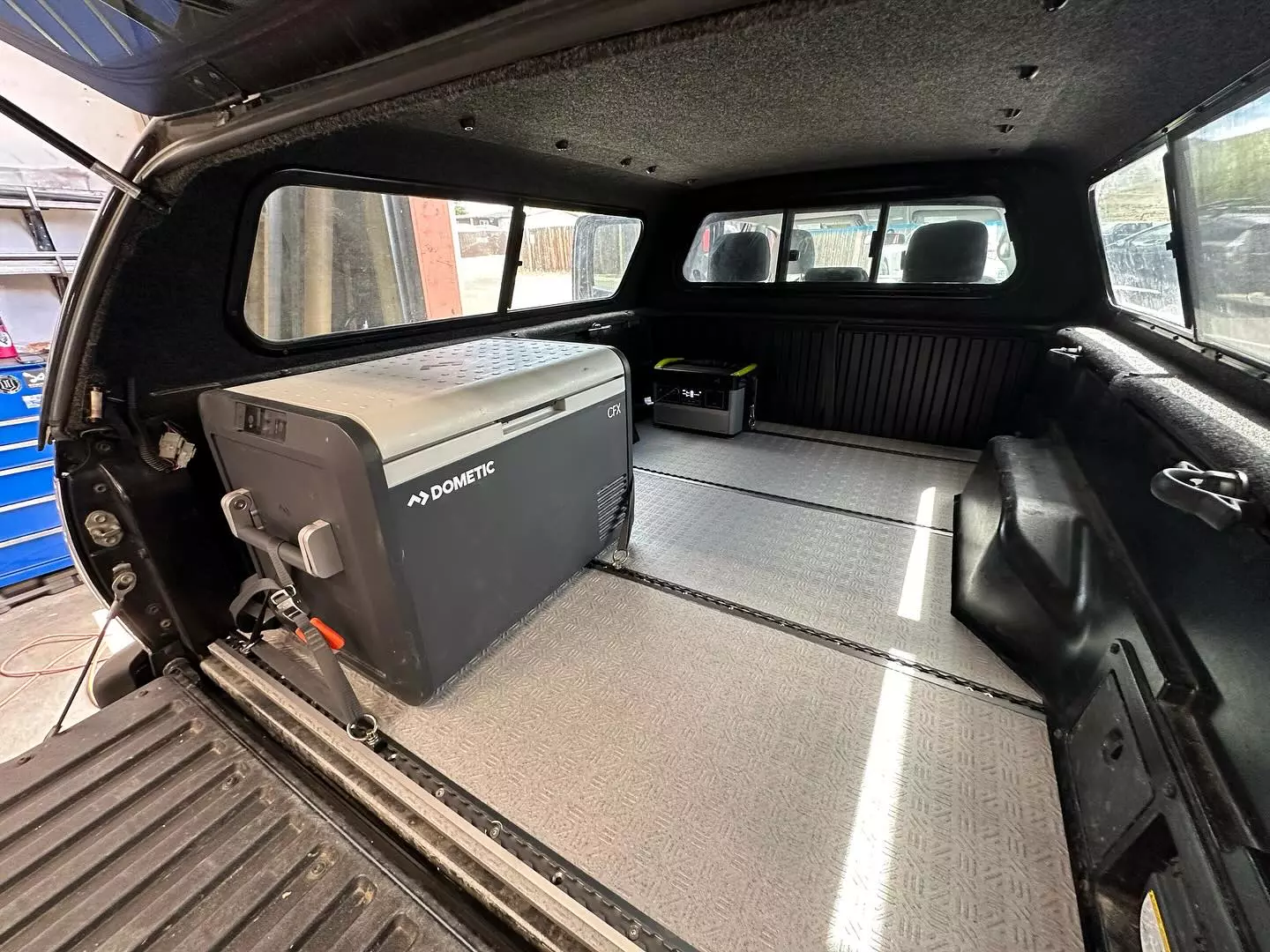 Securing down a fridge is one natural use for the Launch Pad flooring, whether that means a slide or simply strapping it to L-track tie-down points