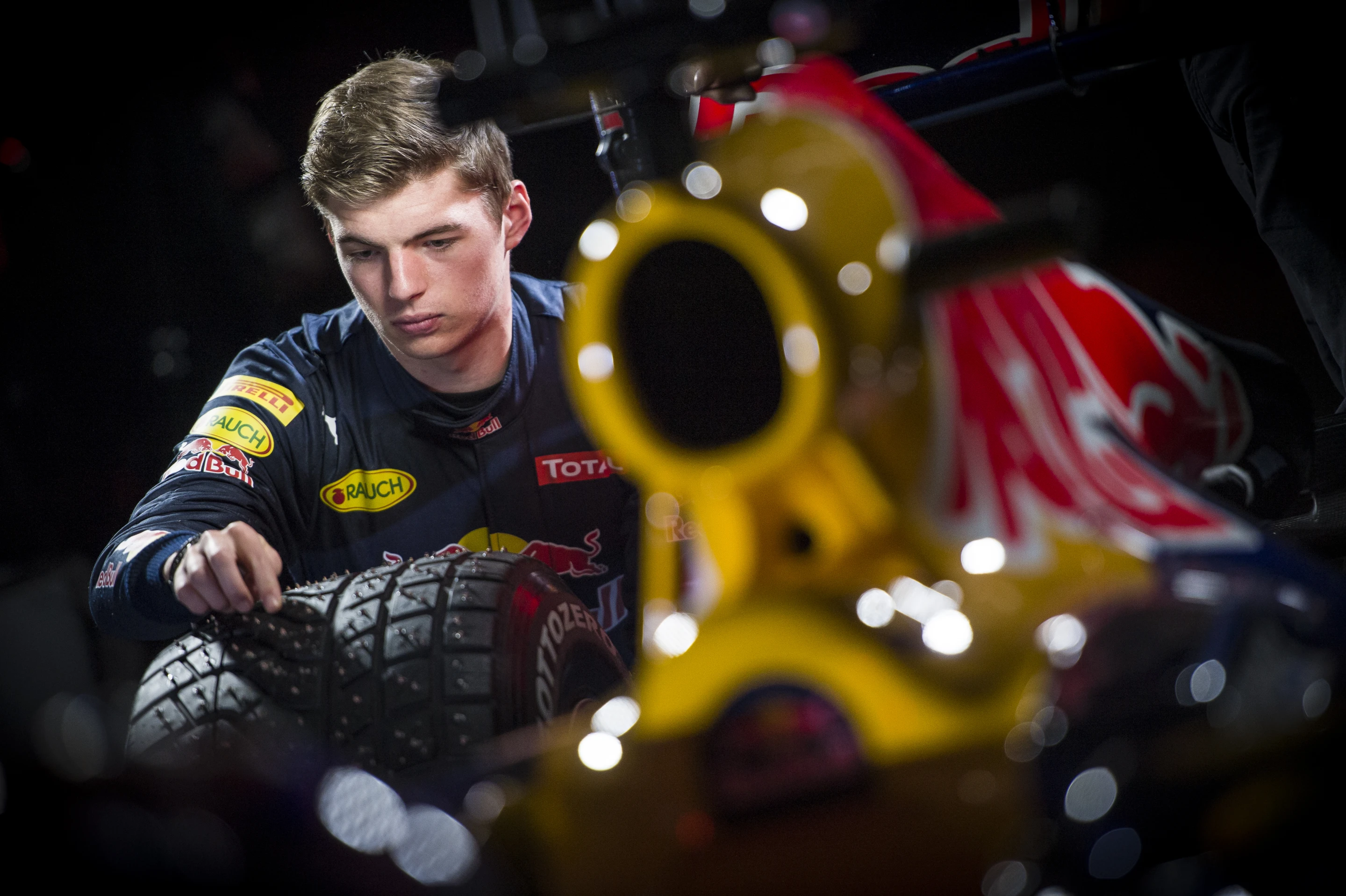 Max Verstappen looks over the studded snow tires