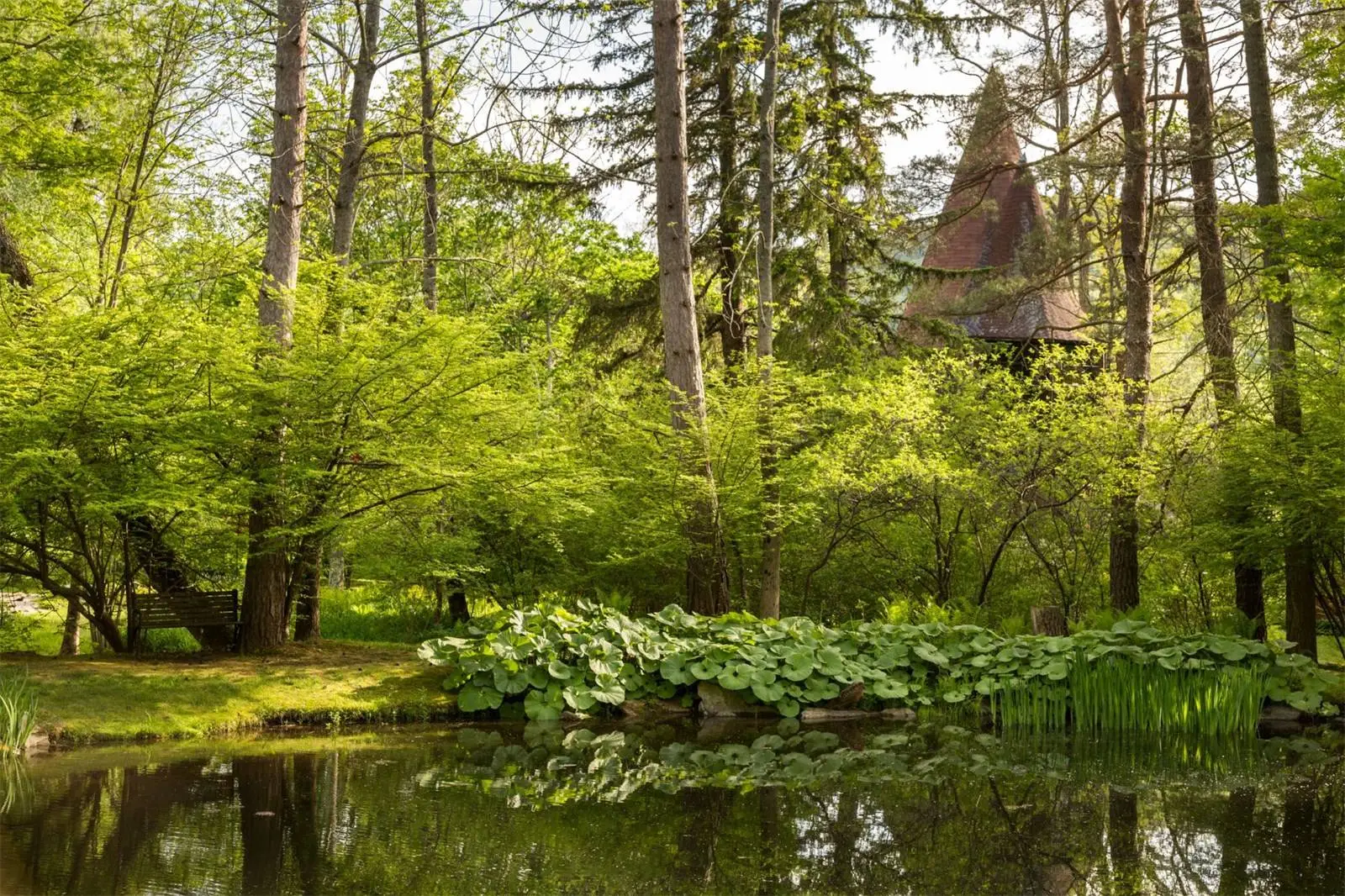 The four acre landscaped gardens surrounding the Tyringham Gingerbread House estate boast bridges, brooks and blossoms