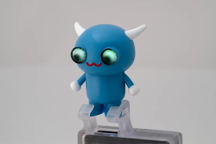 A 3D printed mobile projector accessory with embedded light pipes that direct light to the character's eyes