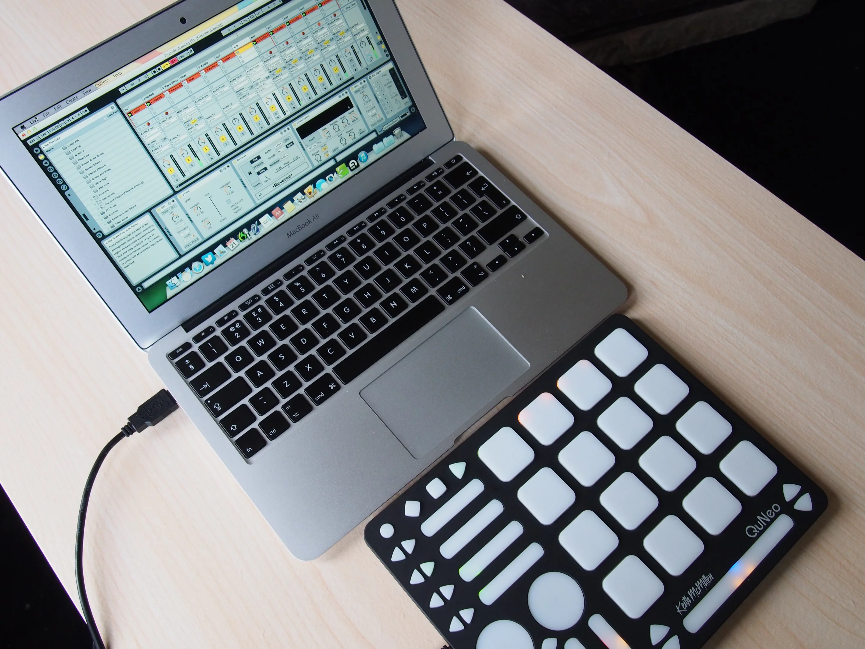 The QuNeo with a MacBook Air 11-inch running Ableton Live is a portable and powerful music platform