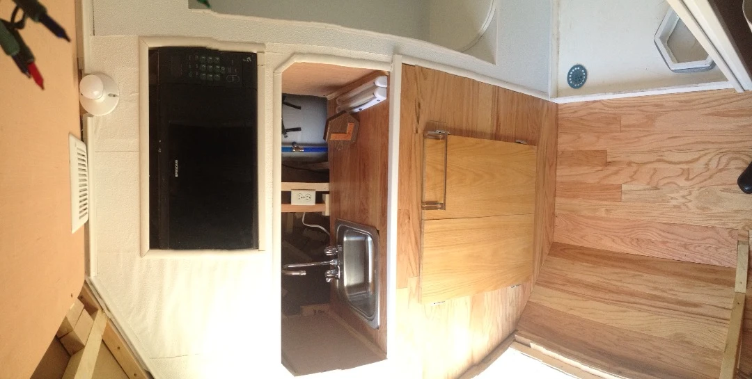 The interior of the tiny home includes shower, hot water tank, microwave oven, double mattress and composting toilet