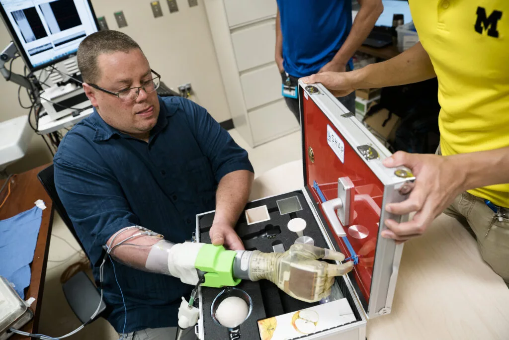 Joe Hamilton, a participant in the study, uses the new system to control a prosthetic hand