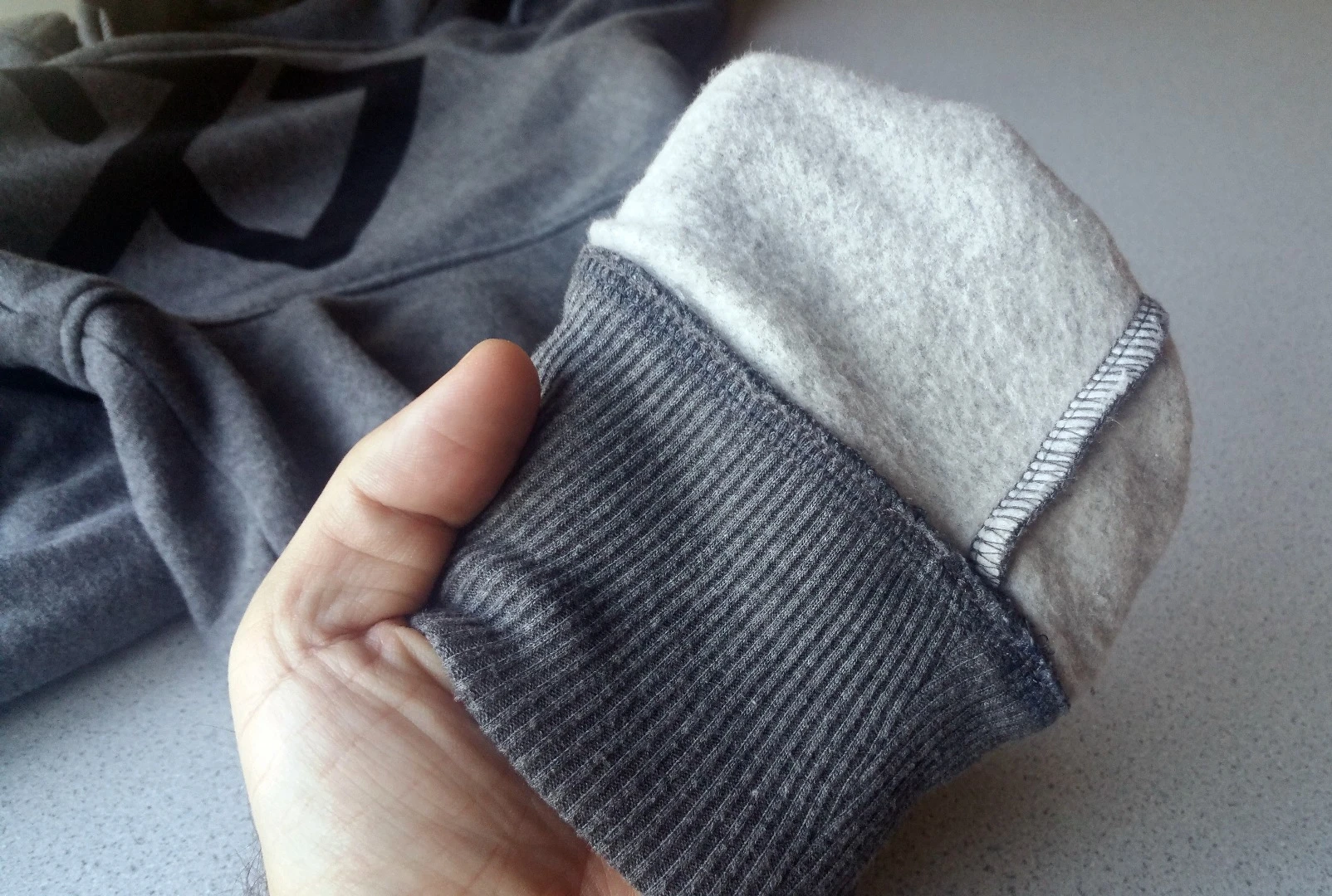 Turned inside out, one arm cuff of the Ravean heated hoodie shows uniform stitching