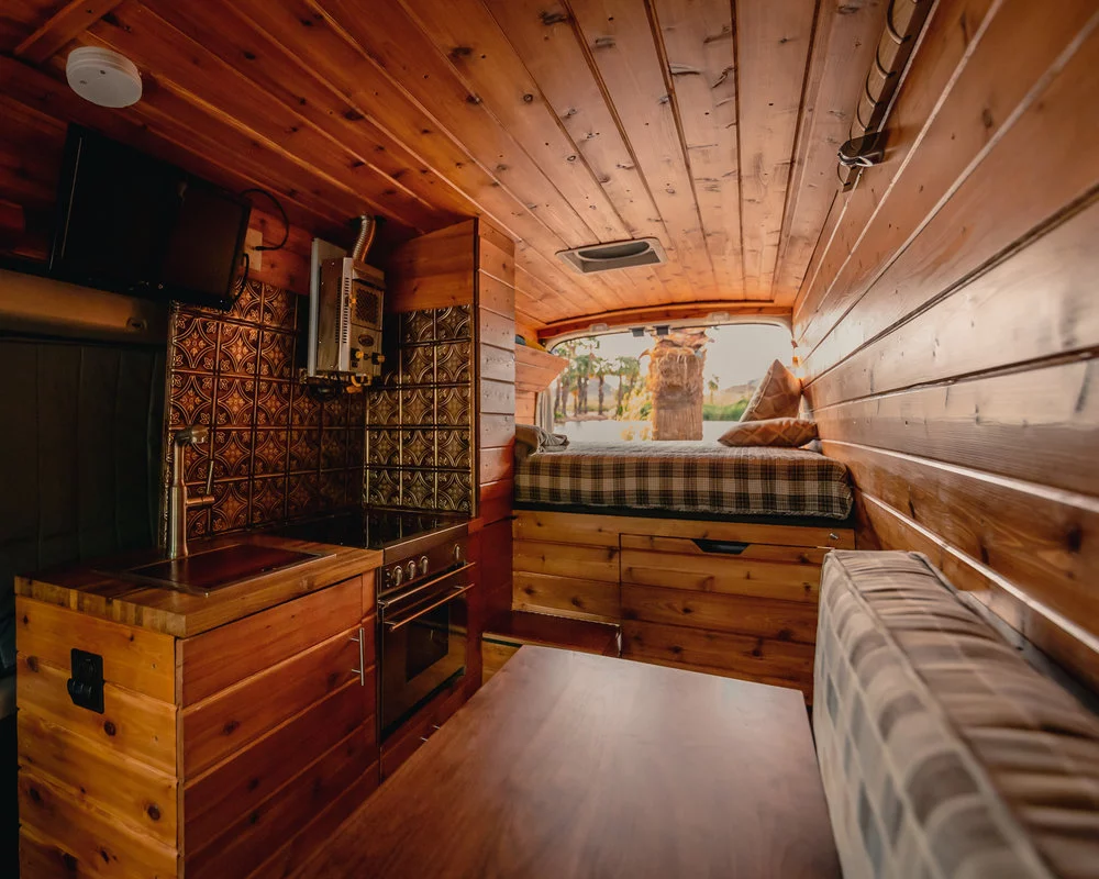 Outside of the foosball table, the kitchen is the highlight of the van, combining a full range, fireplace, tile and more