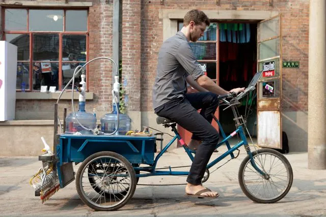 Artist Nicholas Hanna has created a cargo tricycle-based system that prints Chinese calligraphy on the road, in water