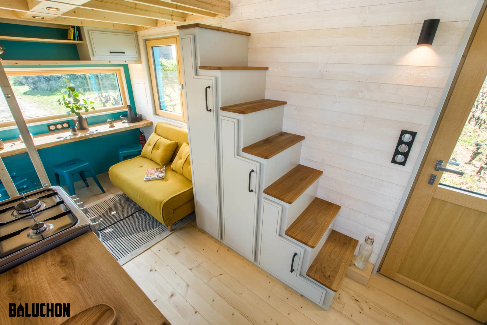Tiny house Sïana's main bedroom is reached by storage-integrated staircase