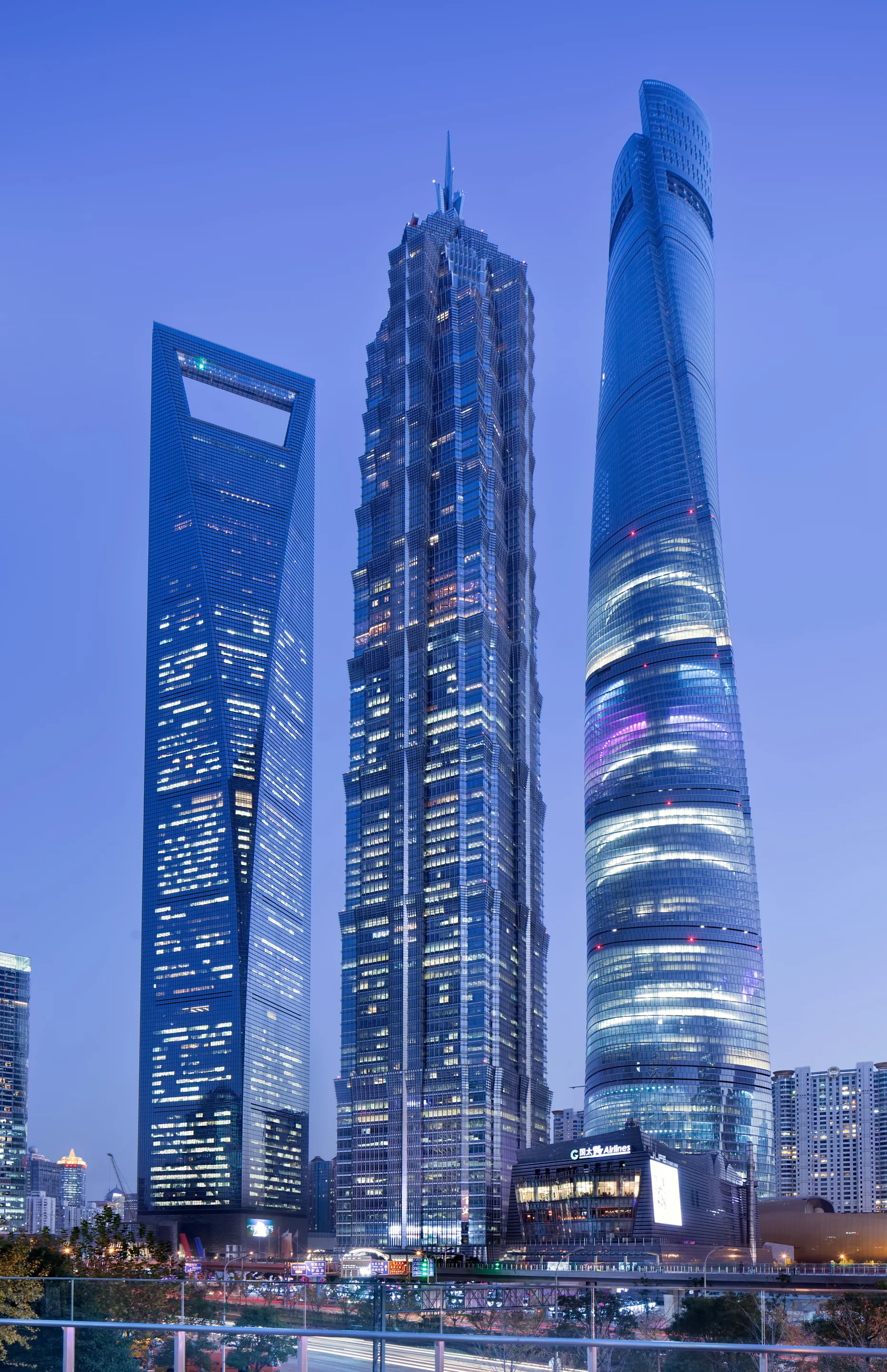 The Shanghai Tower - doesn't need to use reflective glass to control temperature, because it's got two layers of clear glass between 1 and 10 metres apart all the way up. It acts like a giant thermos flask.