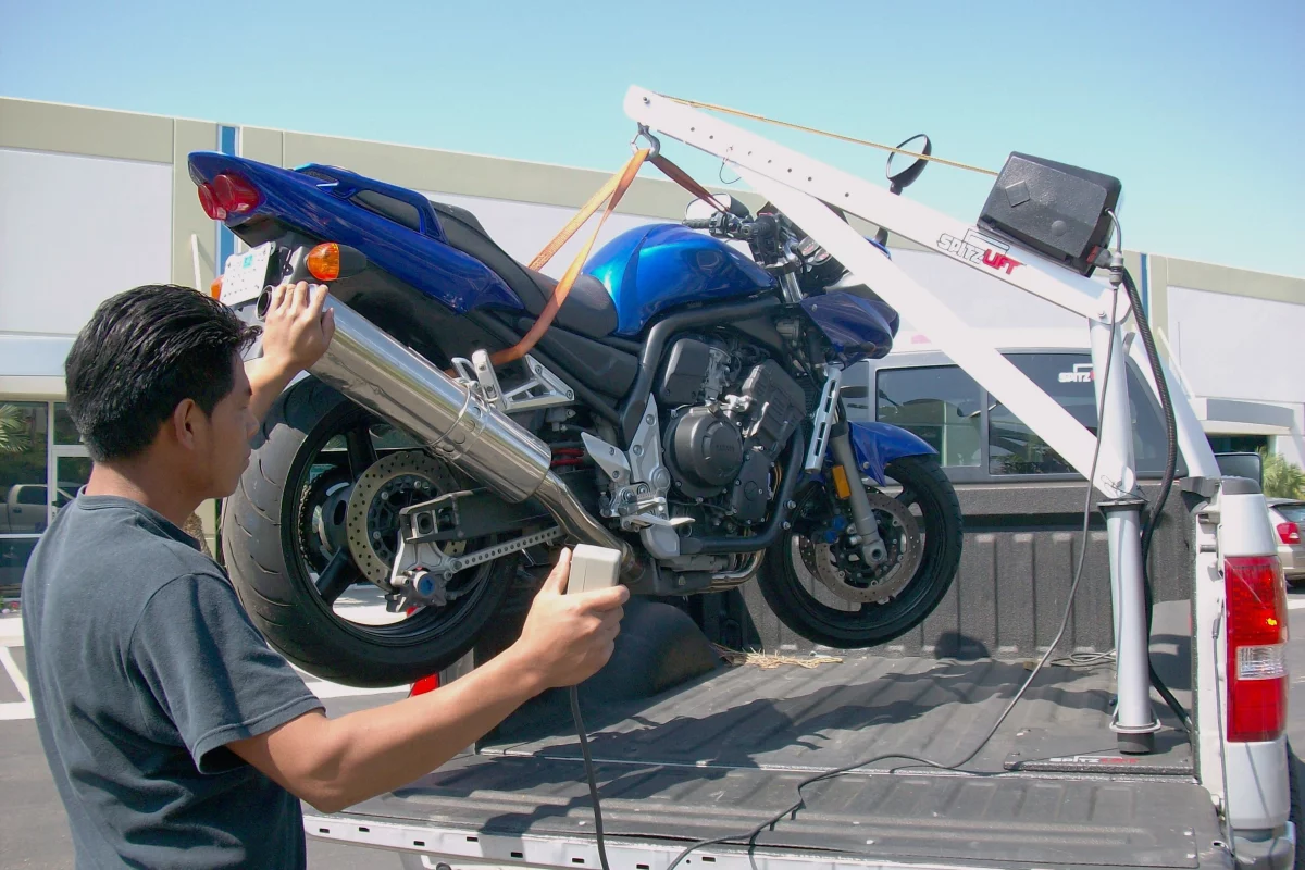 Spitzlift's miniature cranes make lifting a bike into a truck easy