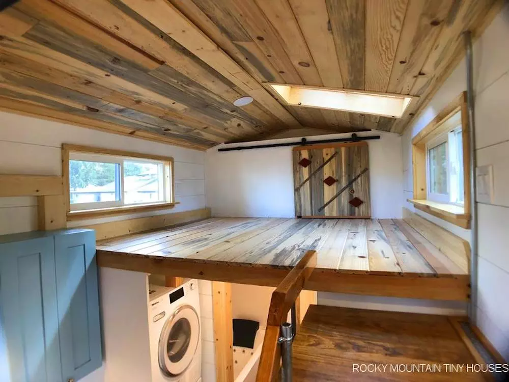 The Bradford 26' Tiny House has one proper bedroom, which is a typical loft-style with a low ceiling and is reached by a storage-integrated staircase