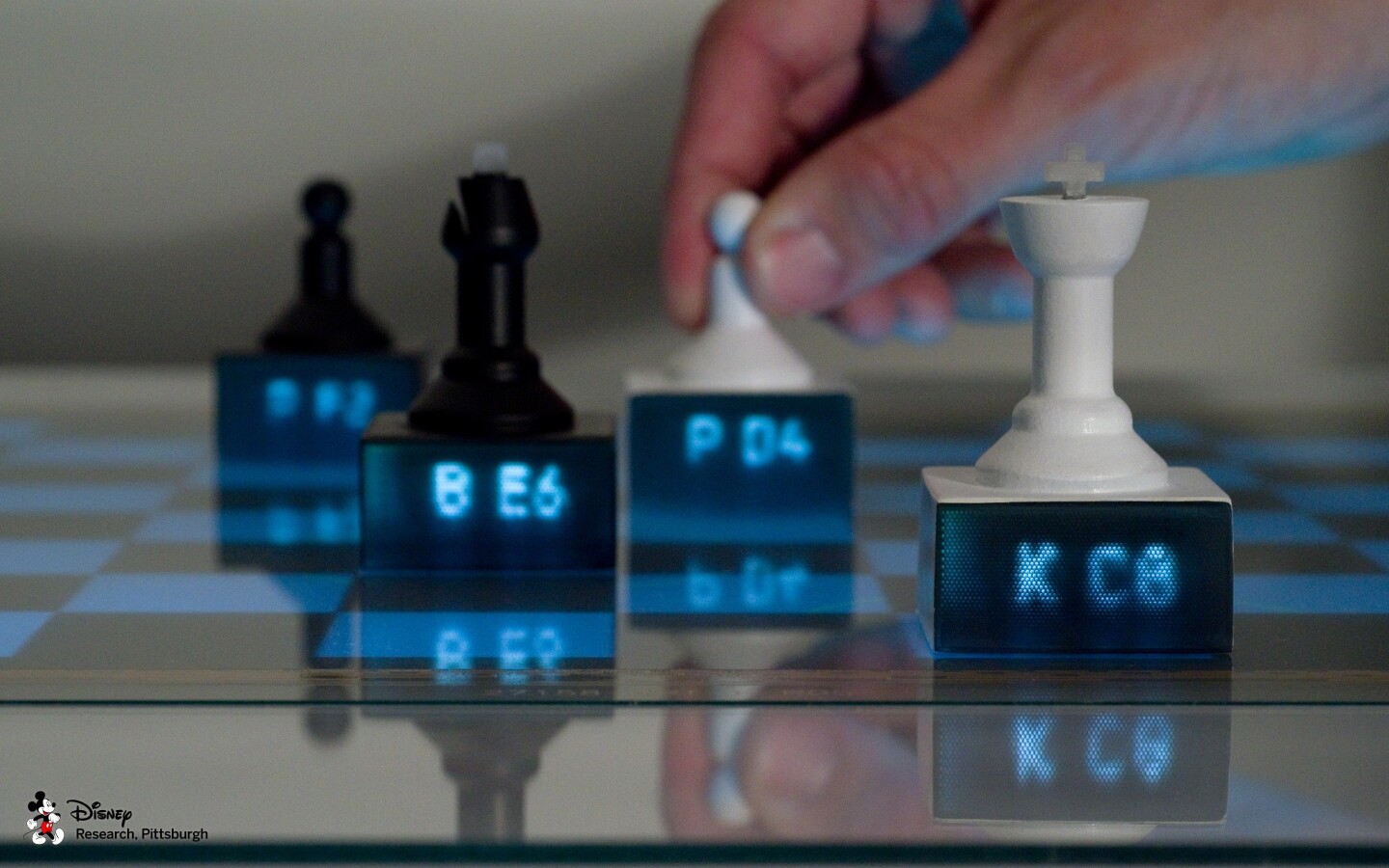 Chess pieces with embedded light pipes display content piped from an interactive tabletop to provide contextual information, such as chess piece location and suggested moves