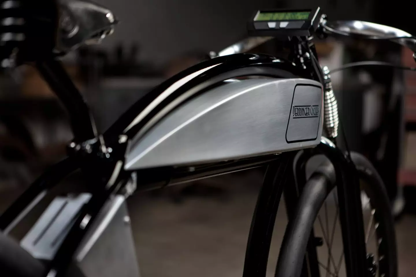 The faux aluminum gas tank hides the battery, the controller sits in a vented case below the seat