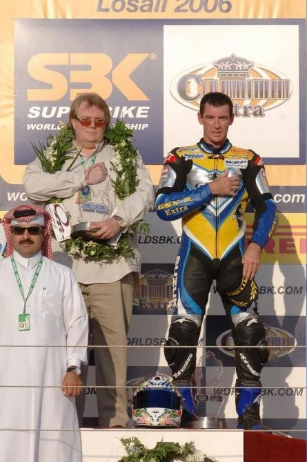 Alstare Suzuki Corona Extra team manager Francis Batta on the rostrum with Corser after leg two
