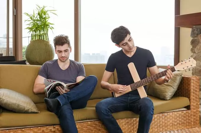 A rotating support at the bridge end of the Cross Guitar gives players somewhere to rest a picking arm, while the large swinging arm in the middle rests against the body for comfort