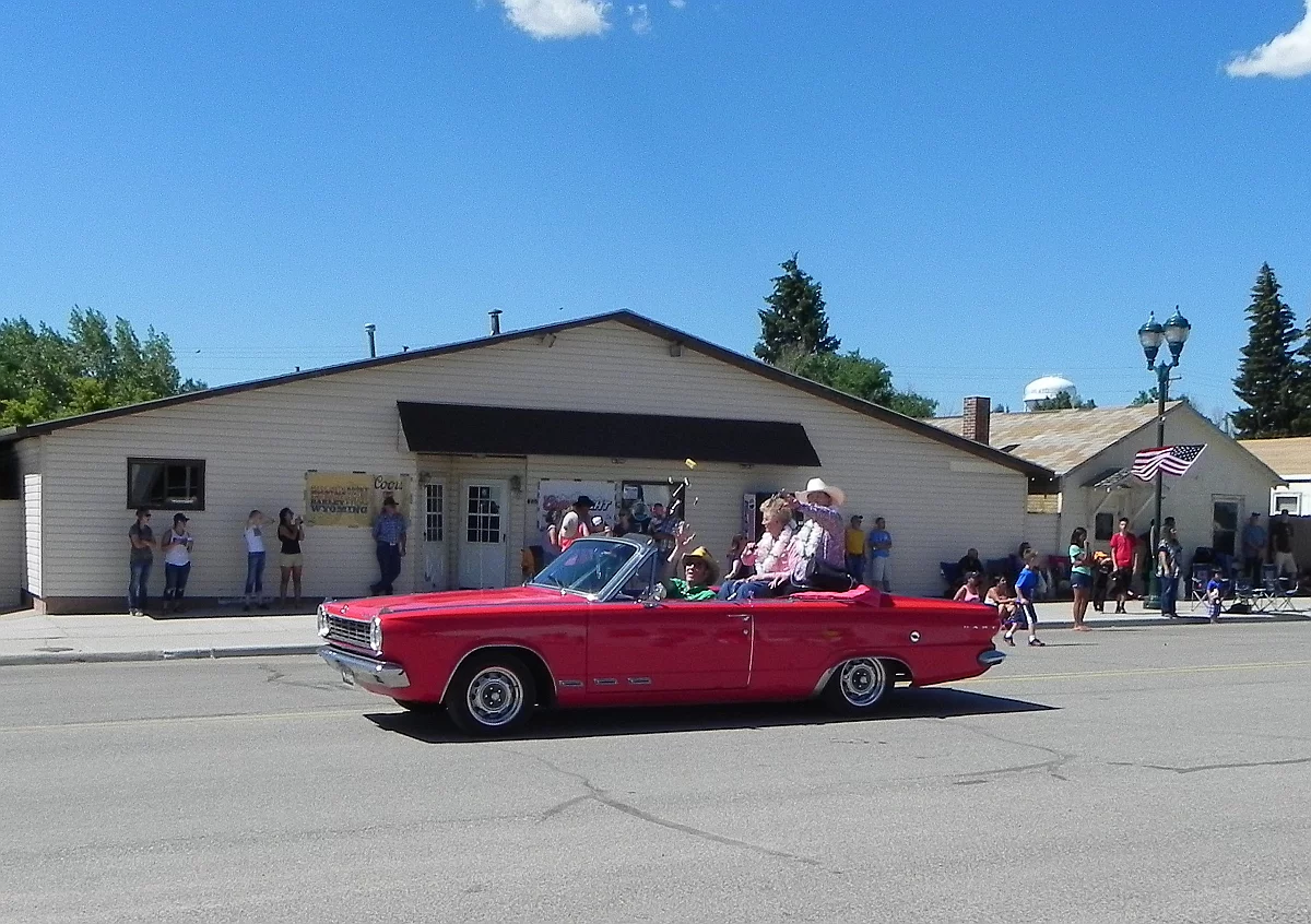 Escorting the grand marshals of the parade held annually by the little town of Albin, Wyoming, the 1965 Dodge Dart GT Convertible with newly-installed RimBlades