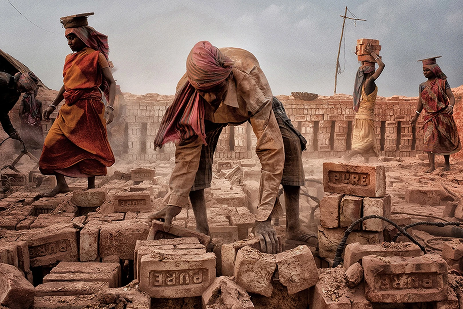 Purelife, by Shibasish Saha, was taken in West Bengal, India, with a Nikon D3300. "In this frame men as well as women are working very hard to feed their individual families. Women forget their pain and work alongside the men in a brick field," says the photographer