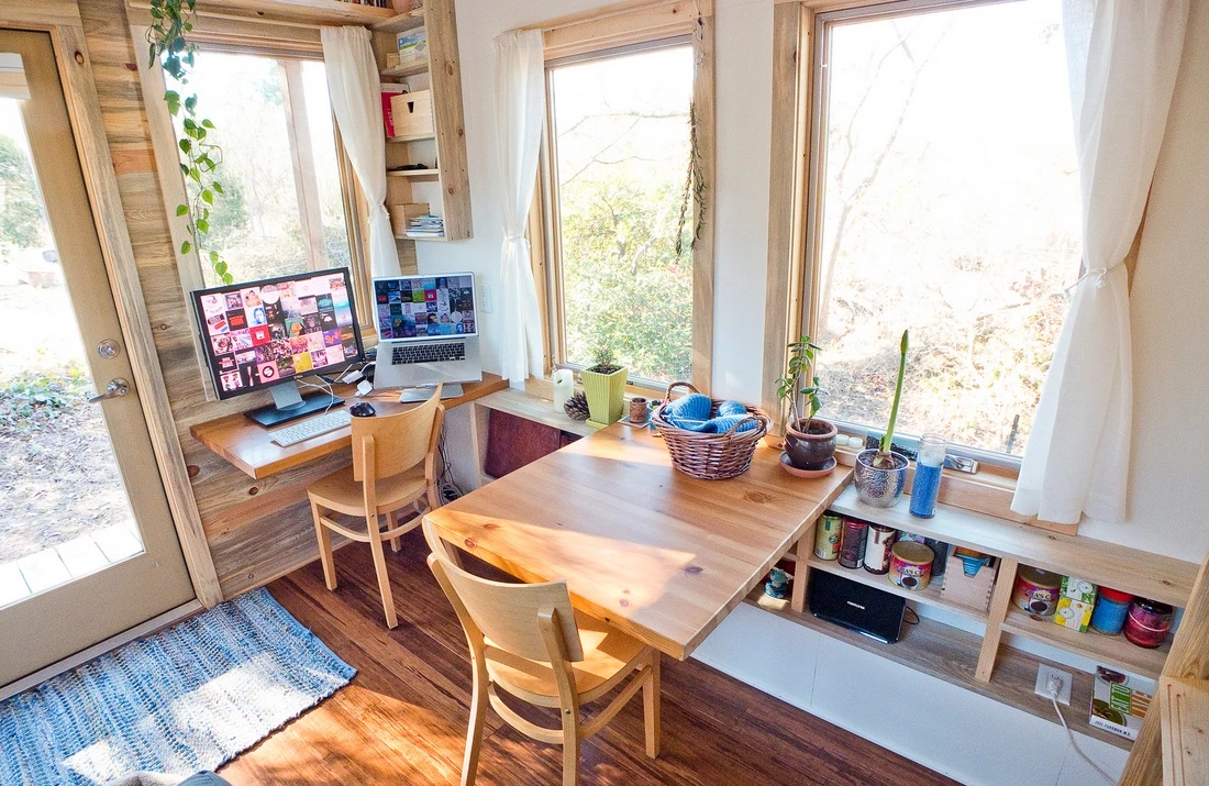 Space-saving furniture such as the foldable desk and dining table have been built into the home's structure