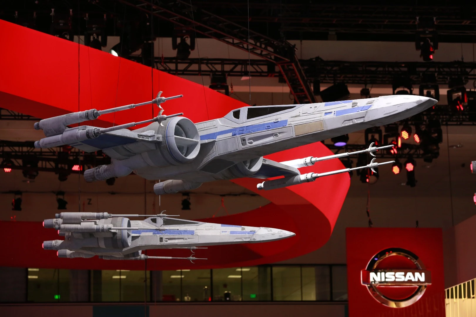 X-wing fighters hang over the Nissan stand at the LA Auto Show