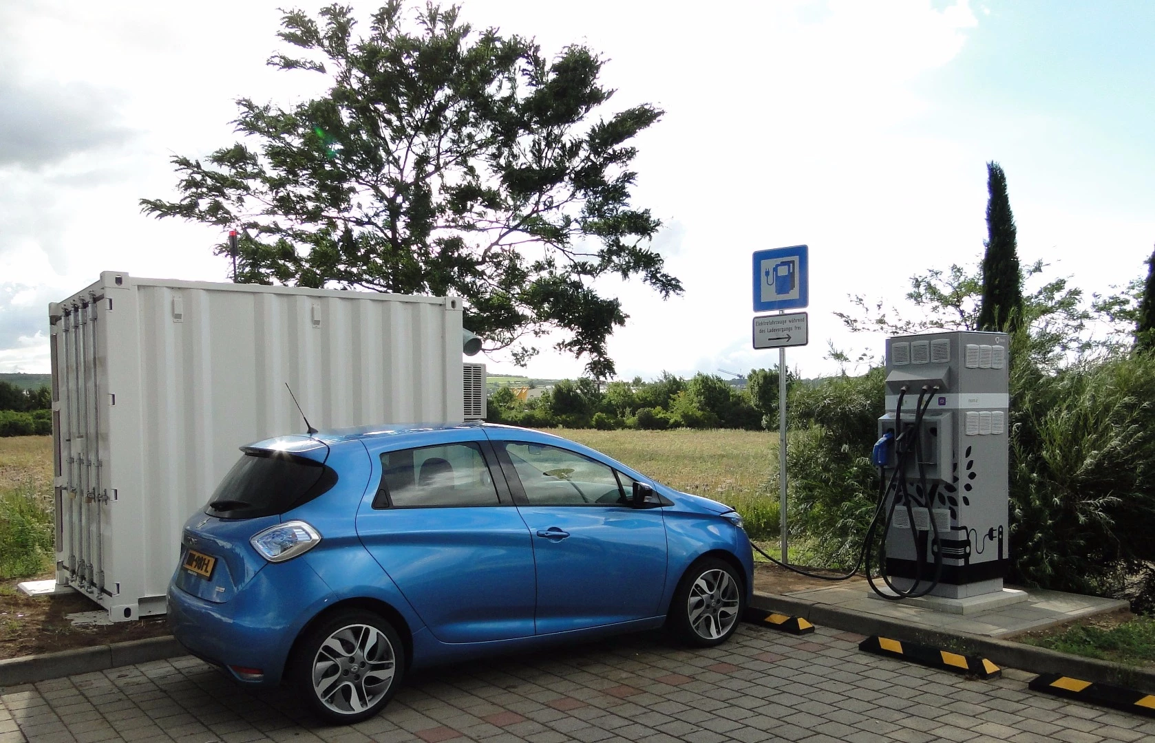 A Renault Zoe getting a quick charge from a station that uses second-life Renault EV batteries