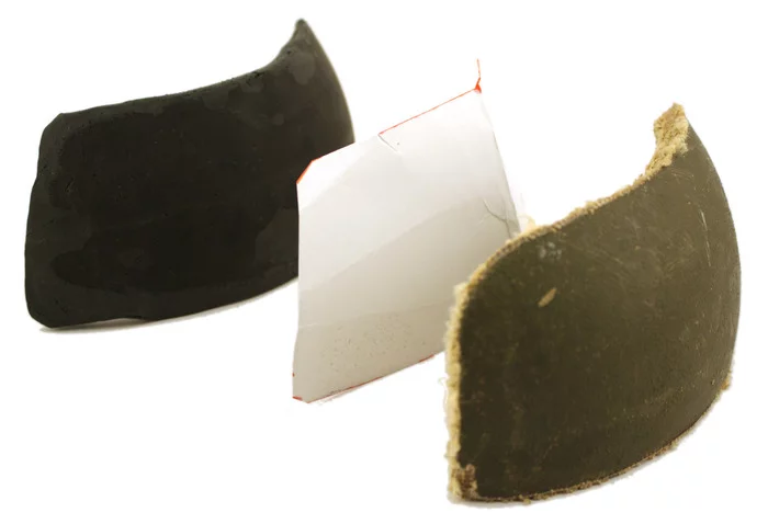 A polymer mock-up of the panel, a paper pattern, and a shooting sample made from a helmet section