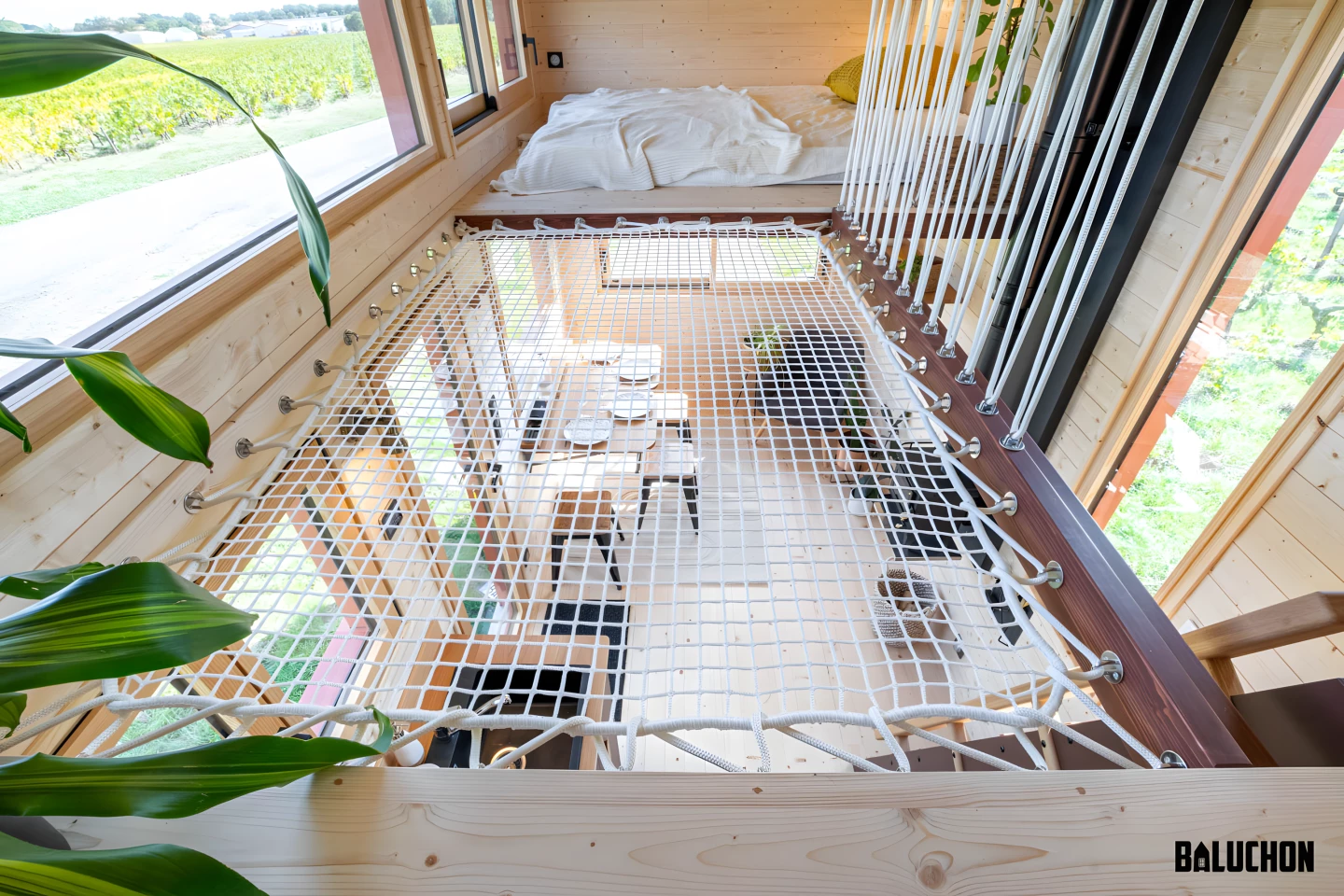 Tiny House Into the Woods' two loft bedrooms are connected by the netted floorspace