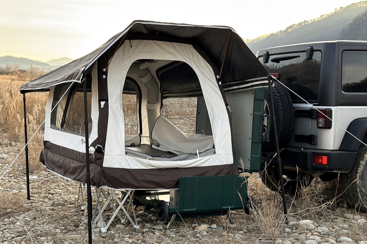 Rolling tent hitches a ride and inflates into above-ground abode
