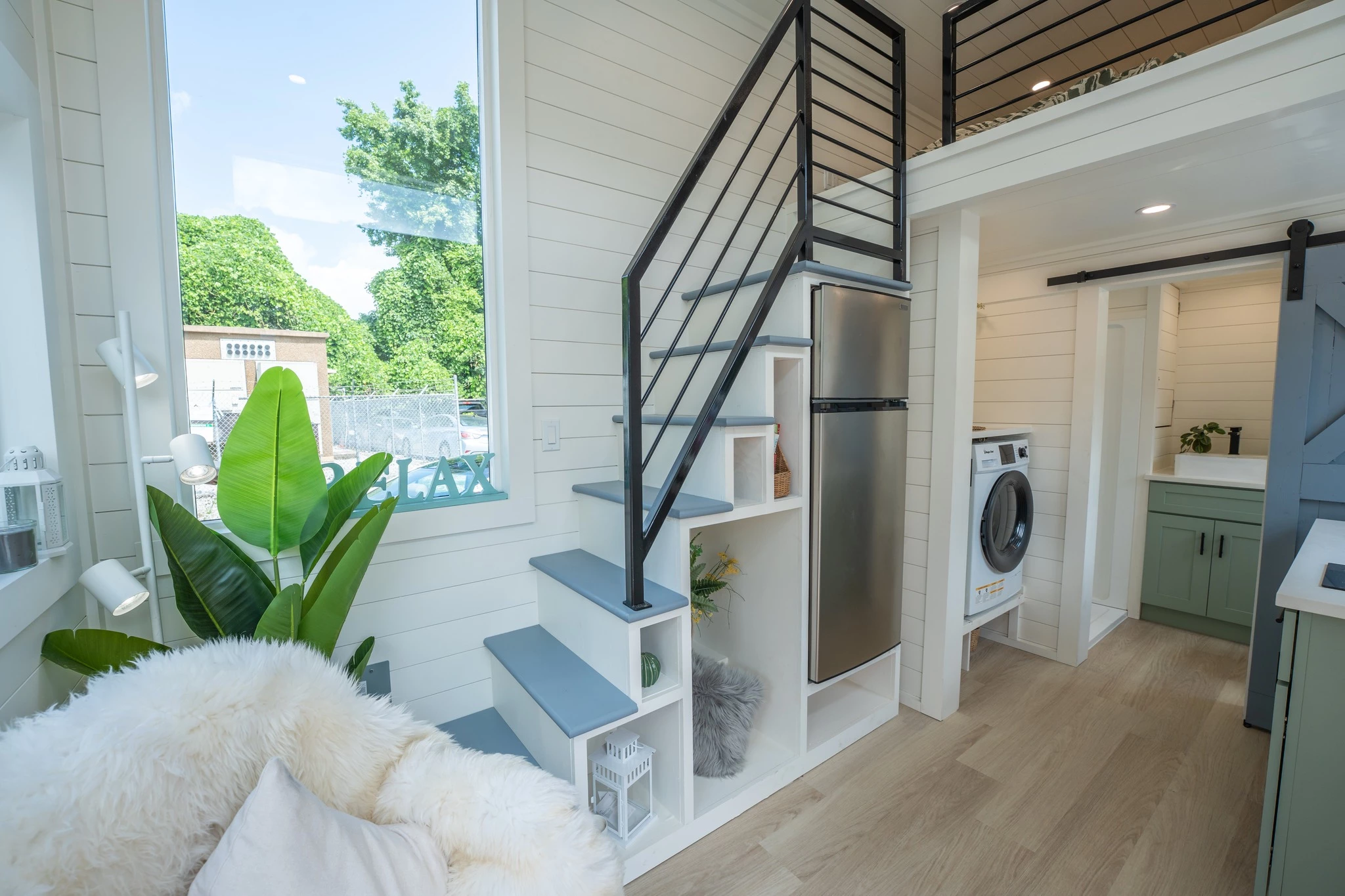 The Genesis V2's bedroom is reached by a storage-integrated staircase