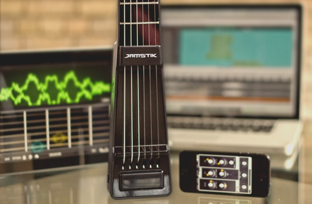 The JamStik wirelessly connects to an iPhone or iPad running an iOS CoreMIDI app or two, such as Apple's GarageBand, or Moog's Animoog